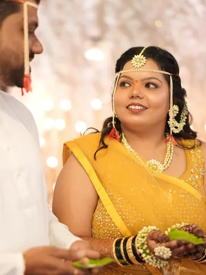 A close-up of the bride looking at her groom, her face glowing with happiness and a touch of natural makeup.