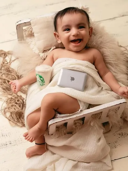 The future CEO. This fun and creative newborn setup with a tiny laptop and coffee cup is a playful take on modern life.