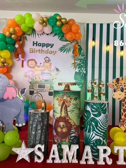 Let's go on an adventure. This jungle-themed birthday party setup is complete with animal cutouts, balloon garlands in earthy tones, and themed props to create a wild and fun celebration for the little explorer in your life.