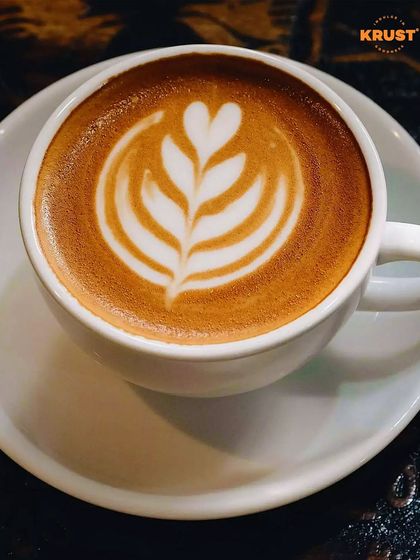 A simple, elegant cup of coffee with leaf-patterned latte art. This is the kind of beautiful result you can learn to create consistently.