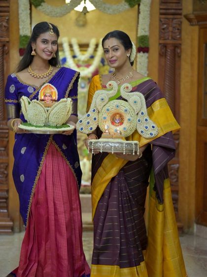 Holding traditional floral arrangements, these women embody the grace and beauty of our festive traditions.