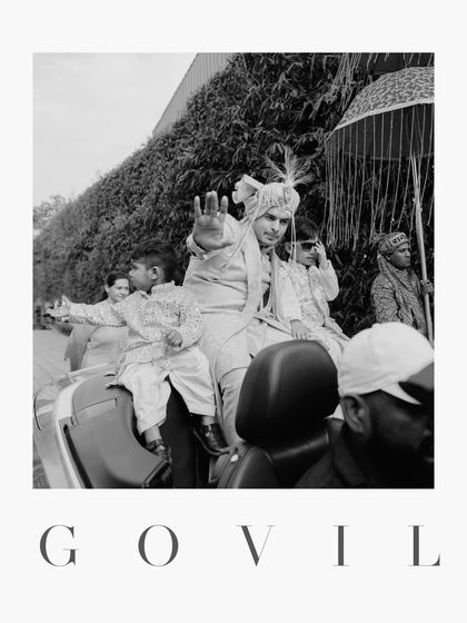 A classic black and white portrait of the groom during his Baraat, capturing a moment of regal confidence.