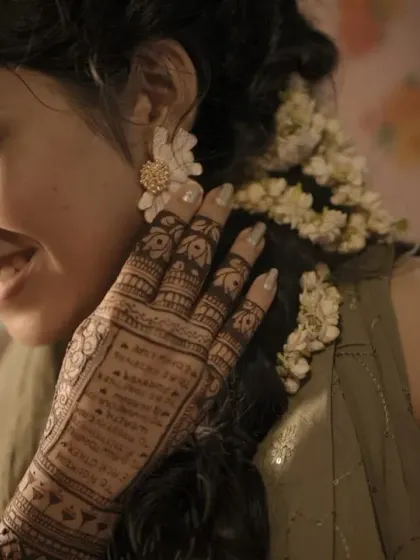 A candid shot of a bride cherishing her mehendi moments, with the dark stain beautifully captured.