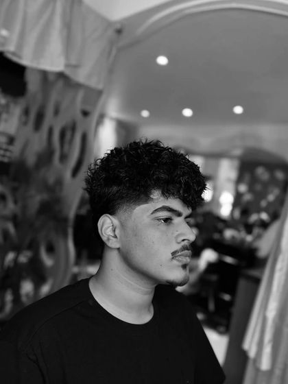 Hair perming is a great way to get a new look. This black and white shot shows the amazing texture you can get from a perm.