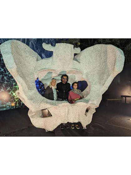 With friends and patrons inside 'KAMA'. The sculpture becomes a gathering place, a shared space for conversation and connection, fulfilling its role as a piece that is both visually impressive and socially engaging.