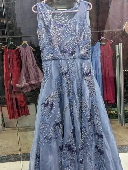 This organza blue handwork engagement gown is a convertible piece. It comes with a detachable ball gown skirt, giving you a grand look and a sleeker look in one.