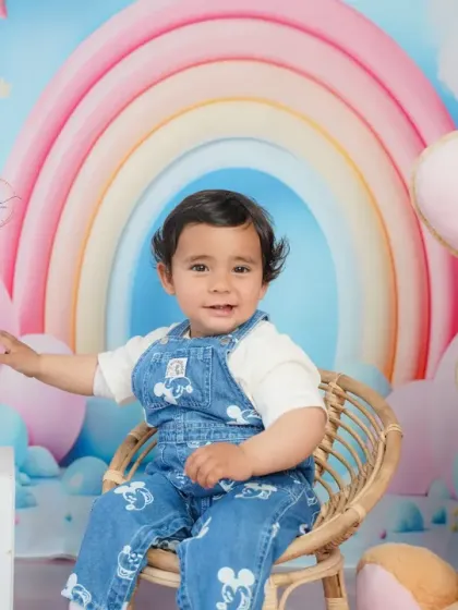 Posing with a giant bunny, this shot adds a touch of whimsy and fun to the first birthday celebration.