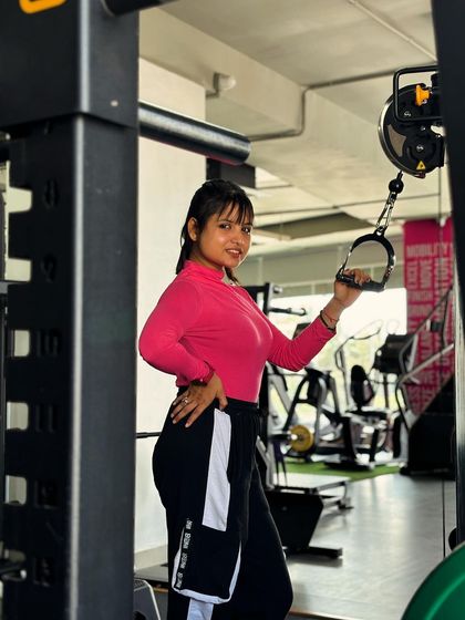 Smiling while getting ready for a tricep exercise. I believe that you should enjoy your workouts and find joy in the process of getting stronger.