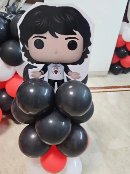 A detailed look at one of the 'Stranger Things' balloon pillars, showcasing the combination of black, red, and white balloons.