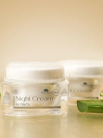 A styled shot of Natuos 365 Night Cream with slices of cucumber, indicating a key ingredient and suggesting a cool, refreshing effect.
