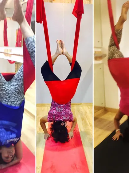 A trio of students enjoying the benefits of supported headstands. It's amazing how much better the world can look when you're upside down.