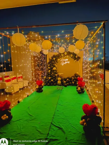 The full view of the terrace walkway, lined with small balloon pillars and leading to the main birthday backdrop. This creates a complete and immersive party experience.