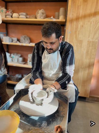 A student gets a feel for the potter's wheel during our unique Improv and Pottery collaboration event.