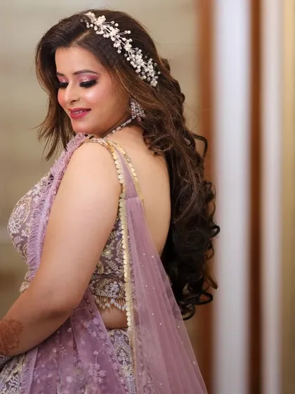 A close-up of the soft curls and shimmery eye makeup. This look is both romantic and glamorous, perfect for an engagement.