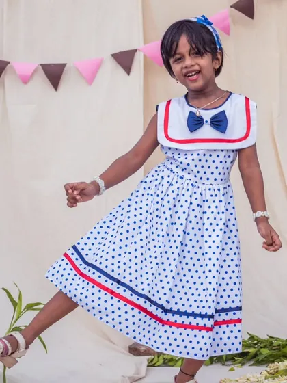 A playful kick in a fun polka dot dress. This design is all about letting her personality shine, with a comfortable fit that's perfect for dancing and playing.