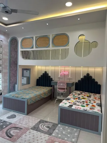 I love designing spaces for the little ones. This shared kids' bedroom features custom twin beds, a dedicated study area, and playful design elements like a Mickey-shaped mirror, creating a room that is both fun and functional.