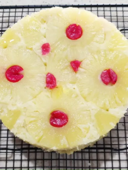 Another perfectly baked pineapple upside-down cake cooling on a wire rack.
