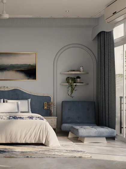 This serene bedroom uses calming blue tones and classical furniture to create a peaceful retreat. An arched niche with built-in shelves adds both storage and a beautiful design feature next to the plush lounge chair.