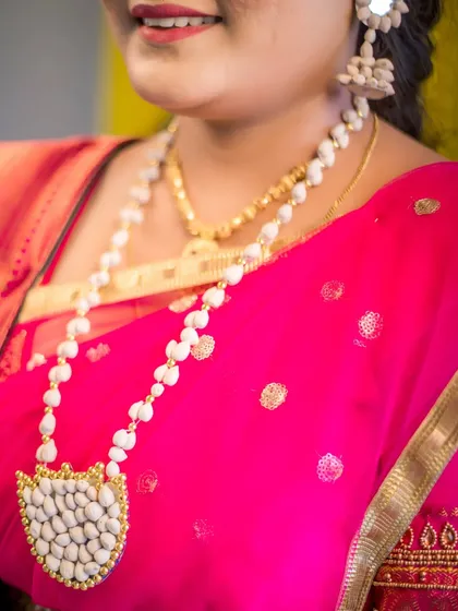 Another detailed shot of the bride's unique necklace, made from seeds. This image emphasizes the craftsmanship and cultural significance of the jewelry, an important element of her traditional bridal attire.