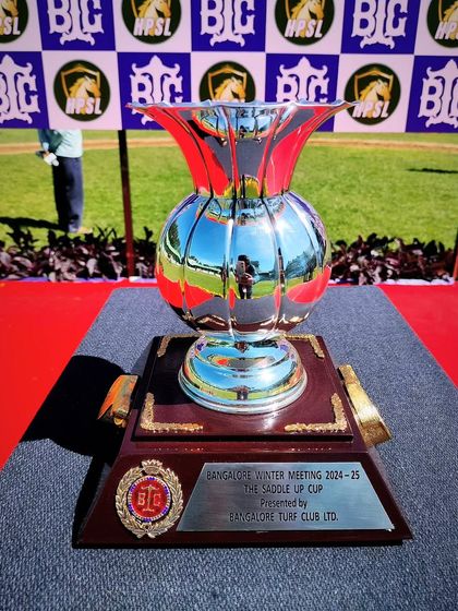 The Saddle Up Cup, a gleaming silver vase trophy.