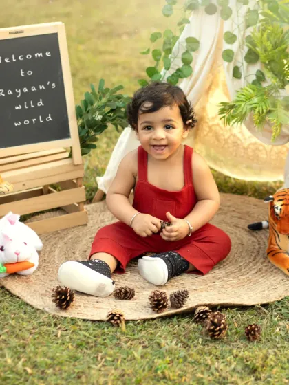 Welcome to the wild world of a one-year-old. The personalized chalkboard sign adds a lovely touch to this adventurous outdoor cakesmash.