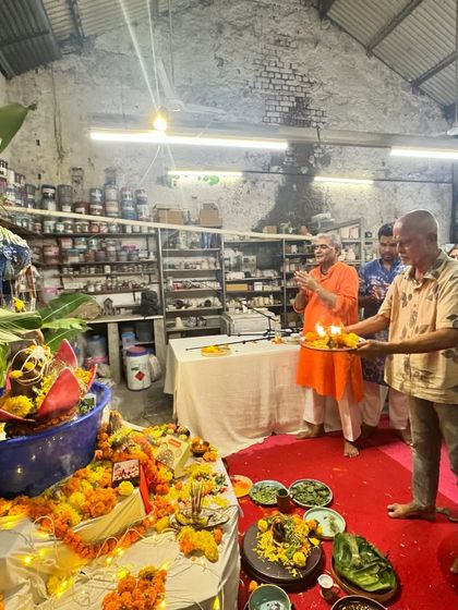 Performing the aarti ceremony during Ganesh Chaturthi. The light from the lamps illuminates the studio as we sing devotional songs together, filling the space with positive energy.
