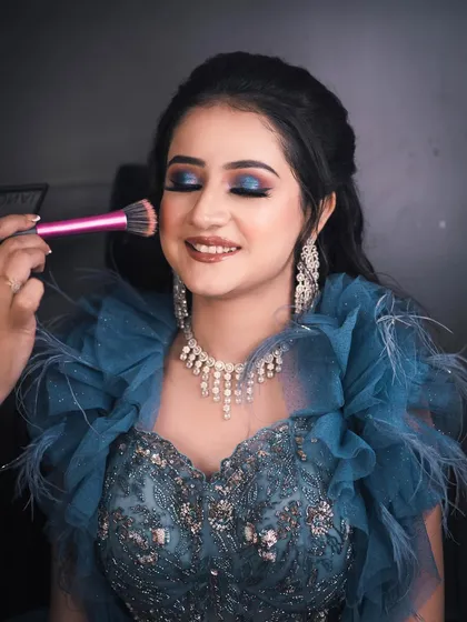 A behind-the-scenes shot of the final touches. This image captures the artistry involved in creating a perfect, blended blush application for a natural-looking flush.