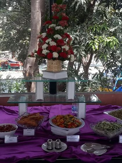A beautiful outdoor buffet setup for a corporate function. We handle all the details, including table arrangements and floral decorations, to create a welcoming atmosphere.