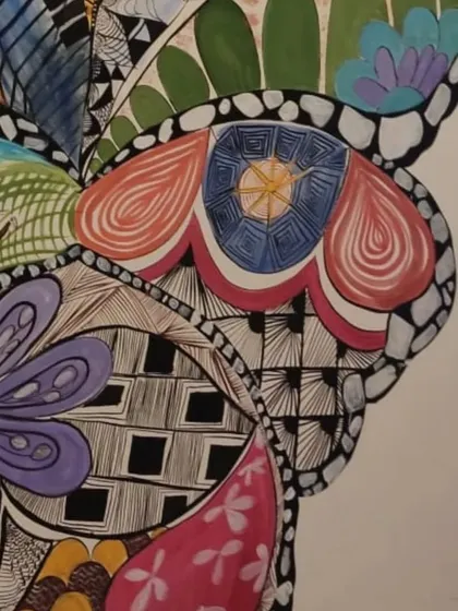 A close-up detail of the intricate patterns within the butterfly wing mural. I combined Zentangle patterns, floral motifs, and other designs to create a rich and detailed piece of art.