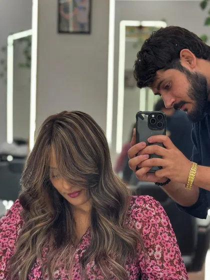 Capturing the perfect shot of a new hair color. This shows the stylist's attention to detail in creating and documenting the Ash Blonde look.