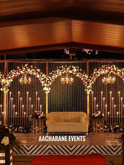 Our creativity extends to outdoor venues, perfect for corporate retreats or evening functions. This stage design combines elegant floral arches with warm, candle-like lighting and a clean backdrop, creating a sophisticated atmosphere that works beautifully in a natural setting.