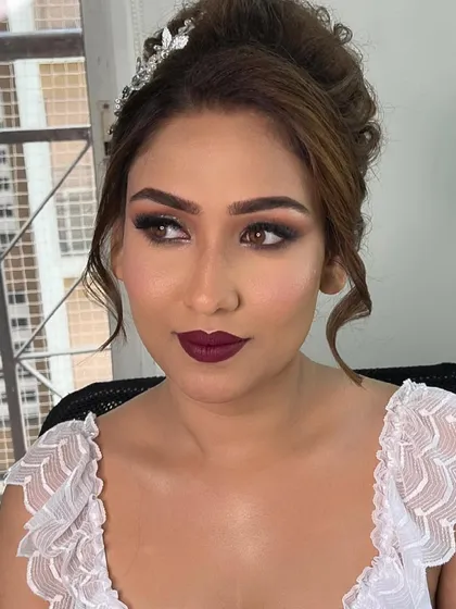 A close-up of the Christian bride's glamorous makeup, focusing on the bold, dark lip and the perfectly blended smokey eye.