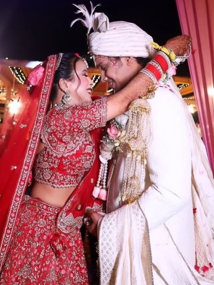A happy moment captured during the wedding ceremony. The makeup is bold and beautiful, with a classic red lip that stands out.