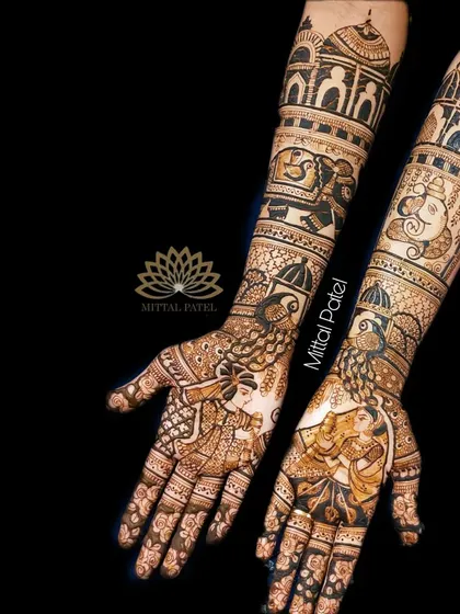 A heavy bridal design with a black background to emphasize the intricate details, including bride-groom portraits, elephant figures, and peacock art.