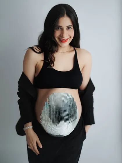 This mama-to-be was just a week away from meeting her little one and wanted a session that was both cozy and quirky. Her family even helped create this amazing mirrorball belly. It was a day full of joy, laughter, and celebrating her beautiful journey.