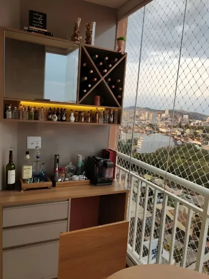 A compact yet comprehensive bar unit designed for a smaller balcony. It includes a mirrored back, a built-in wine rack, and under-cabinet lighting to highlight the glassware. The design also incorporates a safety net, showing how we combine functionality with safety.