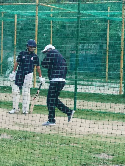 Virender Sehwag demonstrates batting techniques to a trainee during a hands-on net session. Our program ensures that players learn the practical application of skills directly from the masters of the game.