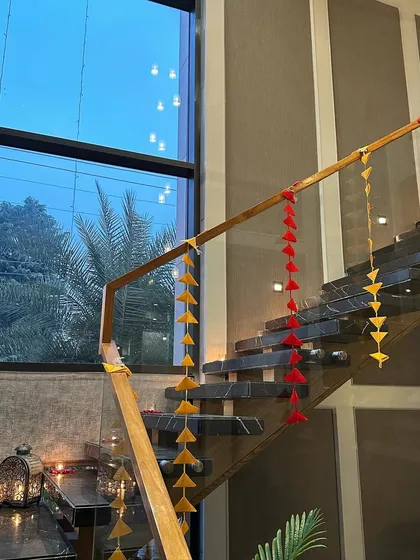 Even staircases get a festive touch. Here, we used colorful hanging tassels to decorate the railing, adding a playful and traditional element to the home decor.