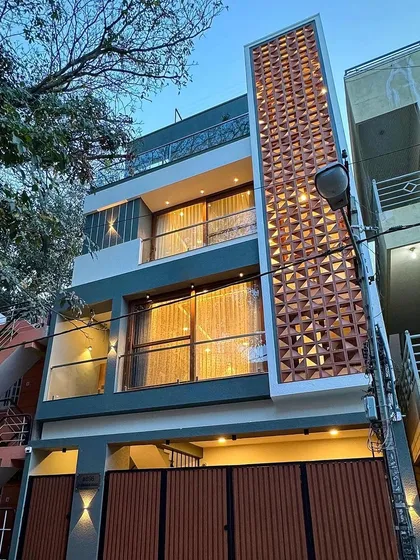 We specialize in maximizing compact urban plots. This modern 4BHK residence was crafted on a 750 sq. ft. site, using a vertical terracotta jali screen that provides both privacy and ventilation while creating a striking architectural statement.