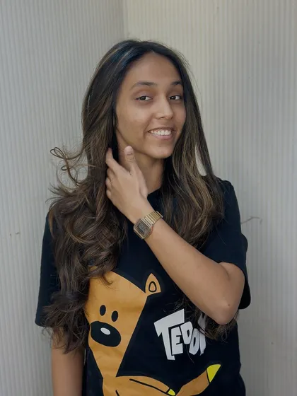 A happy client showing off her new balayage highlights. We designed this look to frame her face and enhance her natural beauty.