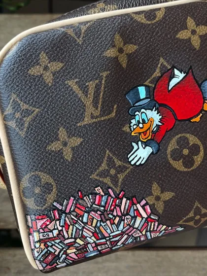 A fun commission for a Disney fan. I painted Scrooge McDuck diving into his money on this Louis Vuitton pouch.