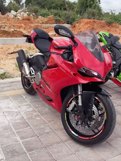 A fiery red Ducati Panigale superbike, a masterpiece of Italian engineering, parked and ready for its close-up at our facility.
