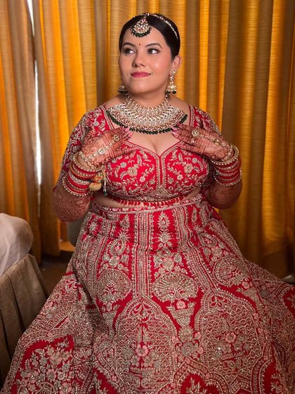 The classic red lehenga bride. For her big day, we created a minimal yet elegant makeup look that allowed her natural beauty and the richness of her outfit to shine. Her smile says it all.