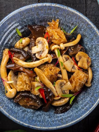 A stir-fry of assorted exotic mushrooms, highlighting different shapes and textures, from the YouMee archives.