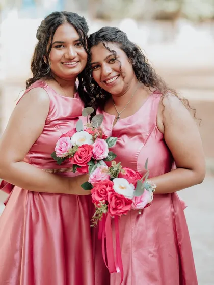 A lovely portrait of two bridesmaids. Their makeup is coordinated yet personalized to suit their individual features and styles.