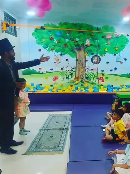 A magician in a top hat performing for an engaged audience of children during a birthday party. You can add a magic show to your package for some extra wonder and excitement.