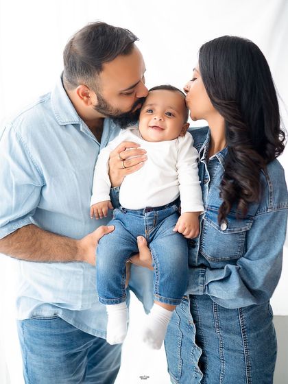 Kisses from both Mom and Dad! This adorable family photo, with everyone in matching denim, is full of love and happy smiles.