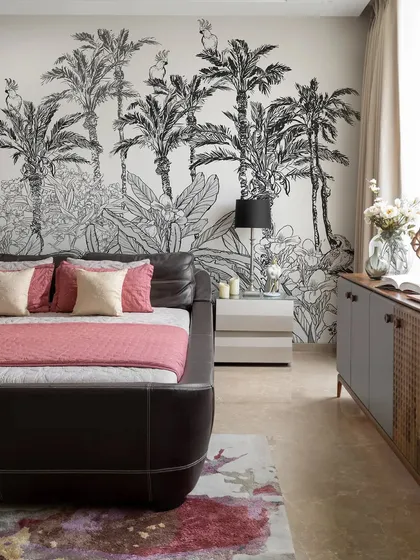 Another view of the tropical-themed bedroom, showing how the large-scale wallpaper creates an immersive and transportive experience. It’s a bold design choice that makes the room feel like a luxury resort.