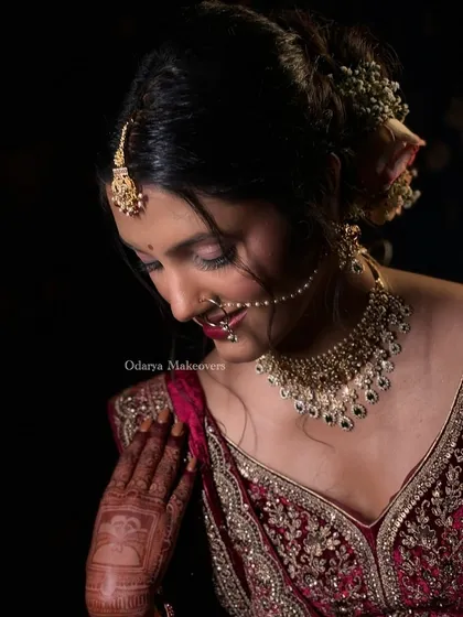 A beautiful downcast pose that highlights the soft pink eyeshadow and the delicate floral hair bun. This is a perfect example of my signature soft glam bridal look.