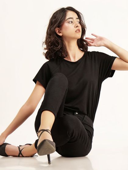 A thoughtful, looking-away pose adds an editorial quality to this studio shot, making it useful for more than just e-commerce.